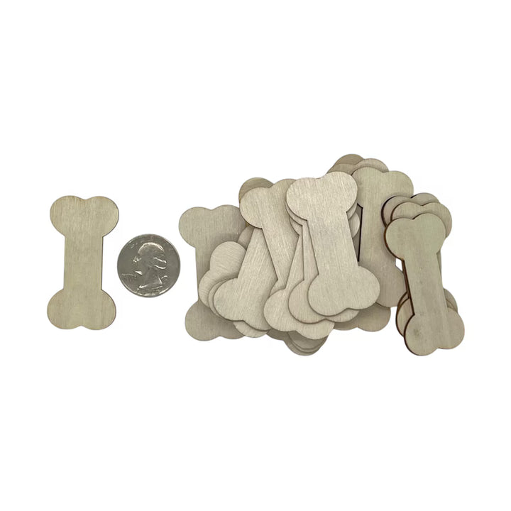 laser cut wood bone-shaped objects with a quarter for scale on a white background