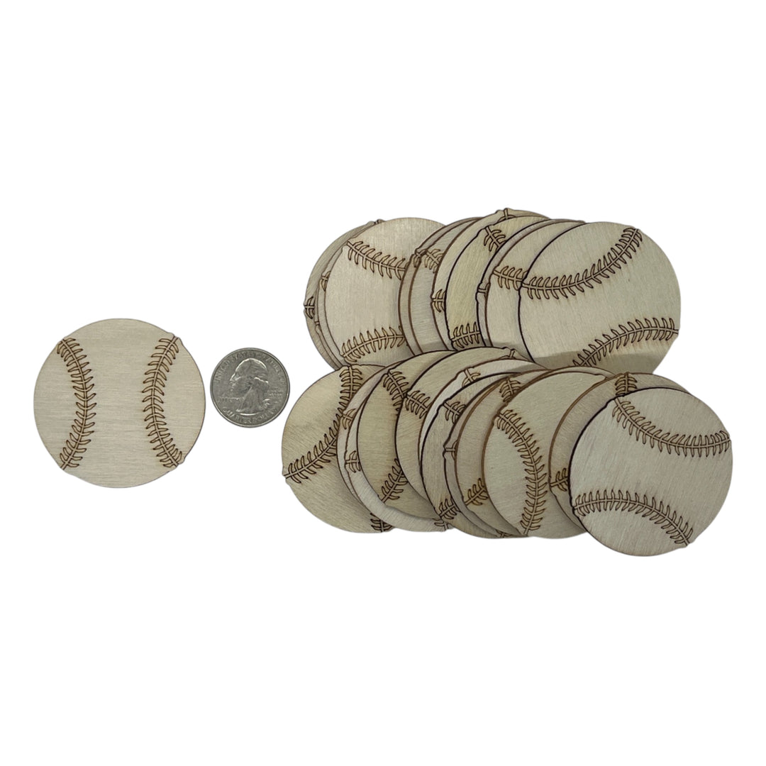 Set of small baseballs with a quarter for scale on a white background
