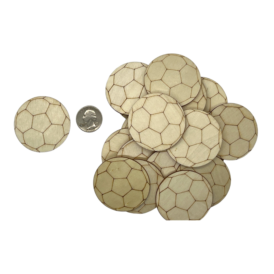 Wooden soccer ball shapes with a coin for scale on a white background