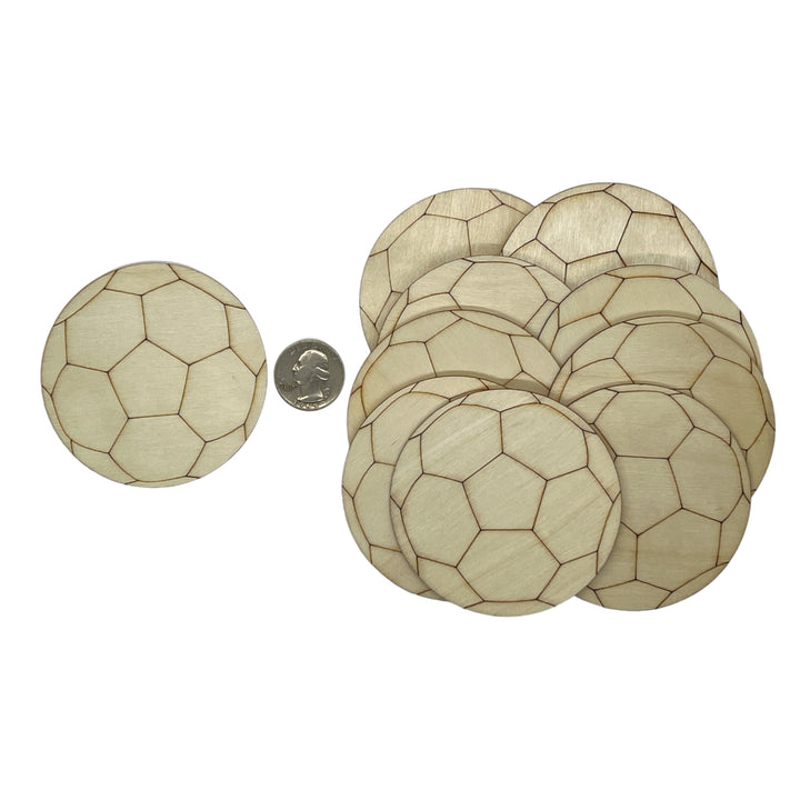 Wooden coasters with soccer ball 
pattern next to a coin for size comparison on a white background
