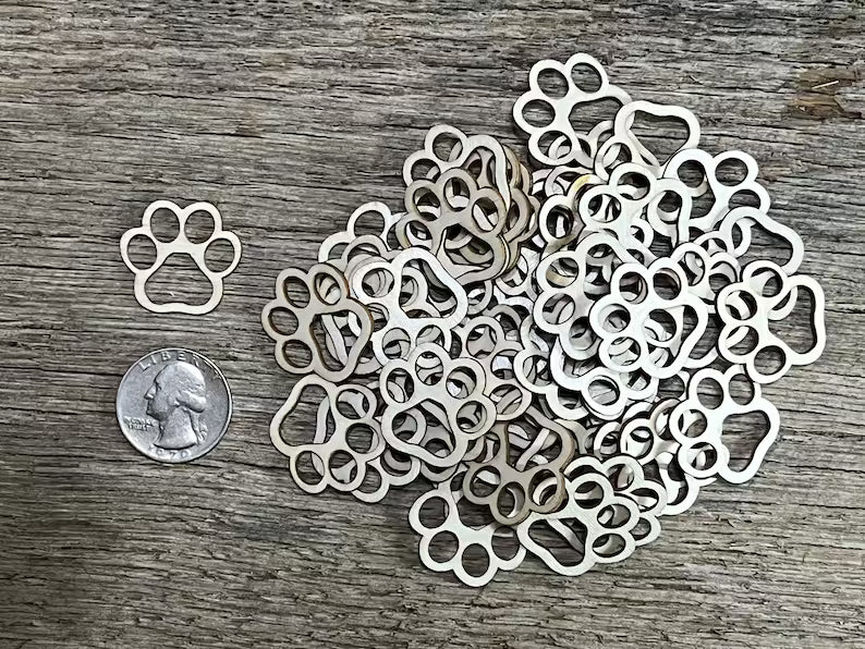 laser cut paw print design on a wooden surface 