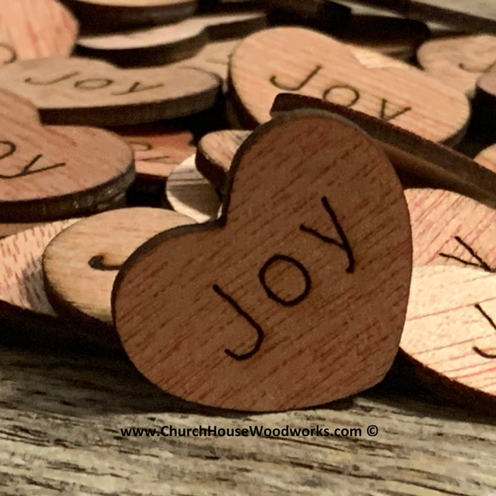 small wood hearts that say Joy on them