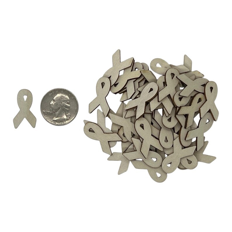 Wooden awareness ribbon shapes with a quarter for scale on a white background